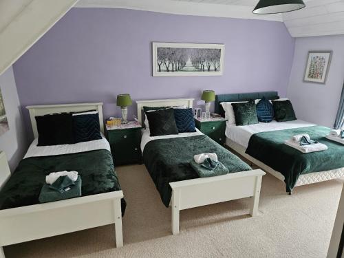 a bedroom with two beds with towels on them at Sheviock Barton Bed & Breakfast in Sheviock