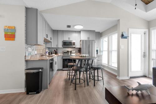a kitchen with a table and chairs in a room at LaBahia 224 in Pensacola Beach