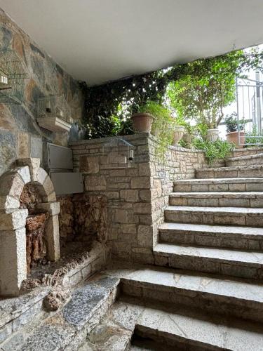 a set of stone stairs in a building with a brick wall at Guest House Adi Hoxha in Berat