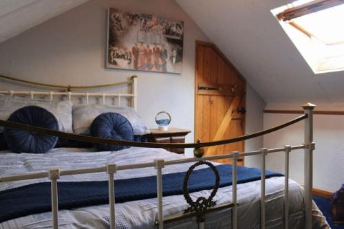 a bedroom with a bunk bed in a attic at Helene - Dog Friendly Family Home on Norfolk Coast in Potter Heigham