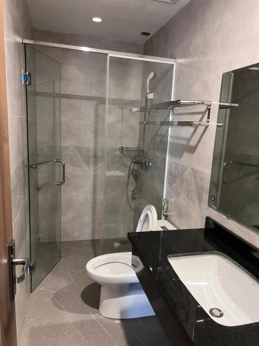 a bathroom with a shower and a toilet and a sink at Hà Vy Homstay in Móng Cái