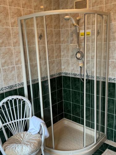 a shower with a chair and a bath tub at Seacrest B&B in Galway