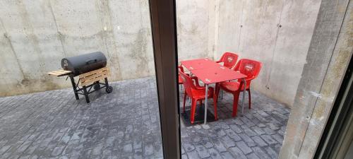 a red table and red chairs on a street at Apartamento Loft con 2 dormitorios, Jacuzzi y Garage in Cambrils
