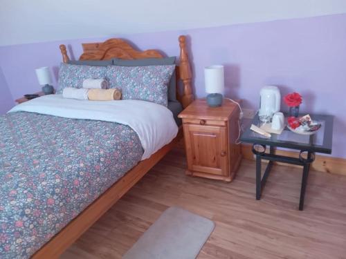 a bedroom with a bed and a side table with a night stand at Ballytigue House in Droíchead an Chláir