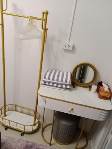 a bathroom with a sink and a mirror on a shelf at STP apartment 3rd floor in Patong Beach