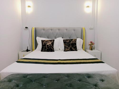 a bedroom with a white bed with pillows at STP apartment 3rd floor in Patong Beach