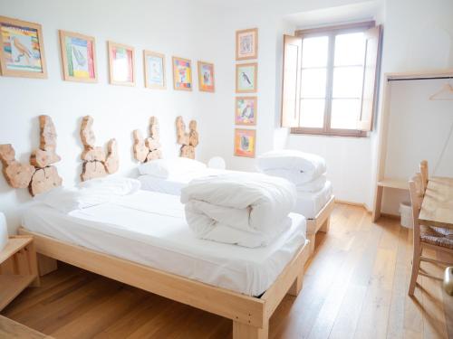 Tempat tidur dalam kamar di Ostello Bello Assisi Bevagna