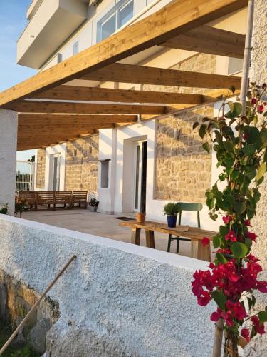 an outdoor patio with a wooden pergola at Il Panorama di Ercole in Monte di Procida
