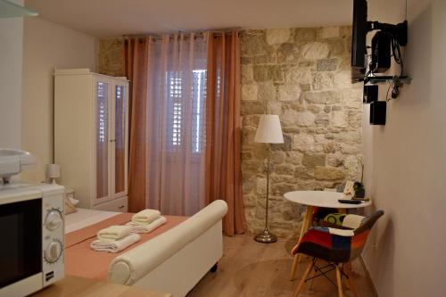 a room with a couch and a table in a room at Split Old Town Suites in Split