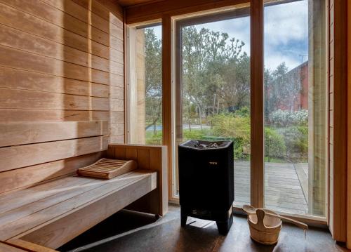 a sauna with a trash can next to a window at Best Western Plus Le Lavarin in Avignon