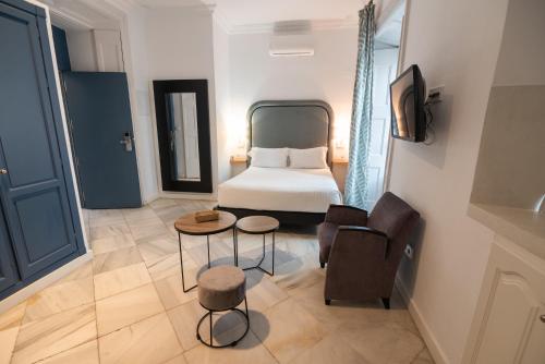 Postel nebo postele na pokoji v ubytování Apartahotel Siglo XIX