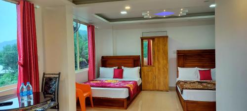 a bedroom with two beds and a window at Himadri munnar holidays in Munnar