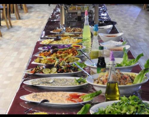 a long table with many plates of food on it at Desert Bedouin adventure in Wadi Rum