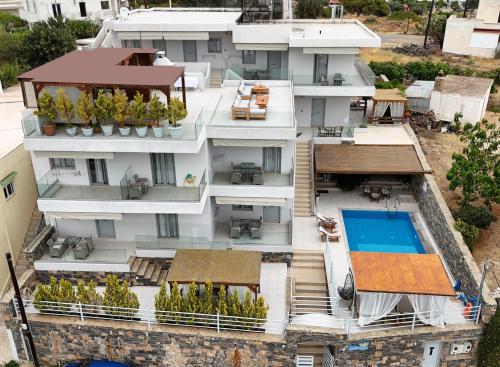 an aerial view of a building with a swimming pool at Asterisuites in Makry Gialos