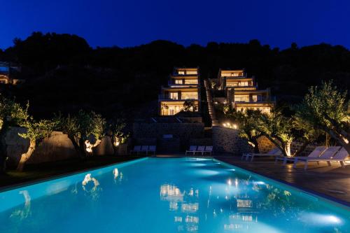 a swimming pool in front of a building at night at Gialova Hills Luxury Villas with Private Pool in Gialova