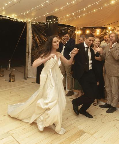 a bride and groom dancing on the dance floor at their wedding at Worlds Apart - River Front Guest Farm & Camping in Bonnievale