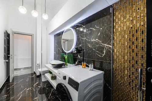 a bathroom with a white sink and a mirror at AYASI Luxury Apartment Predeal in Predeal