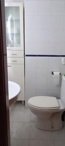 a white bathroom with a toilet and a sink at luxury homes Marbella sun beach and pool in Marbella