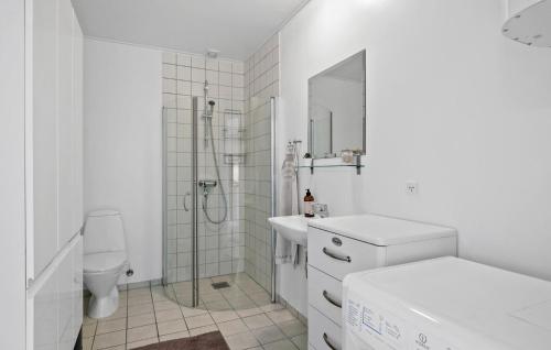 a white bathroom with a shower and a toilet at Amazing Apartment In Allinge With Wifi in Allinge