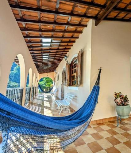 a hammock in the hallway of a house at Casa Central Hospedagem in Miguel Pereira