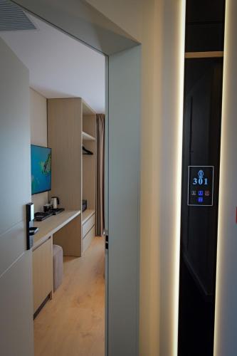 an open door to a bathroom with a sink at Hotel Teuta in Sarandë