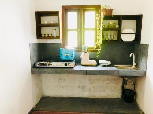 a kitchen counter with a sink and a window at Bimsara Mount Villa in Weligama