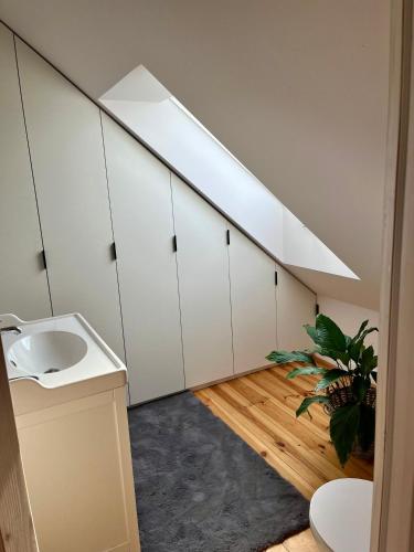 a bathroom with a sink and a skylight at Winter Heaven in Strzelce