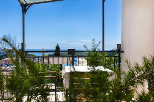 a table and chairs sitting on top of a balcony at Studio with terrace & sea view in Vrsar