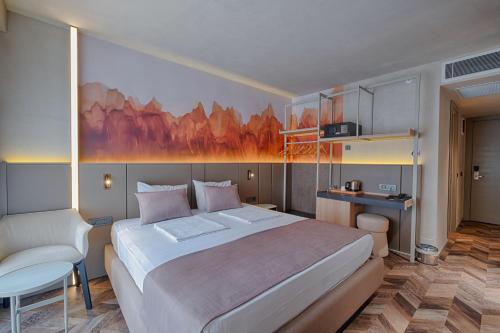 a bedroom with a large bed and a table at Kleopatra Dreams Beach Hotel in Alanya