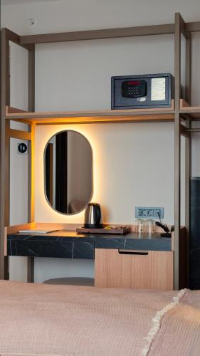 a bedroom with a desk with a mirror and a bed at Kleopatra Dreams Beach Hotel in Alanya