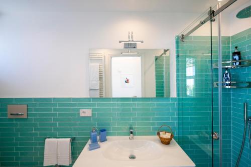 a bathroom with a sink and a mirror at Dimora GiuEla in Positano