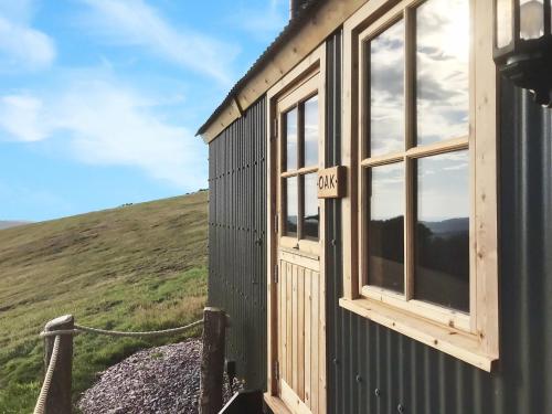 a tiny house with a window on a hill at Oak Hut Wiveliscombe in Wiveliscombe