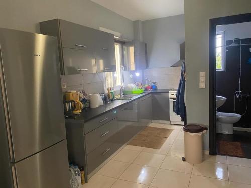 uma grande cozinha com um frigorífico de aço inoxidável em Βίλα στην Πάτρα em Patra