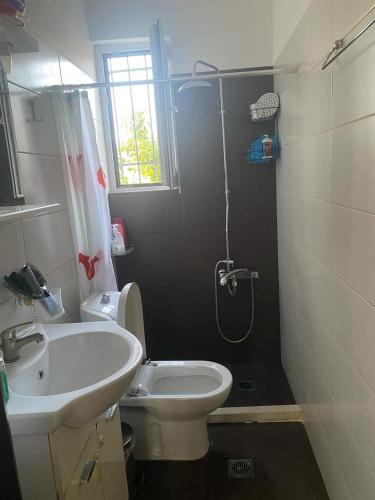 a bathroom with a shower and a toilet and a sink at Patras Ressort in Patra