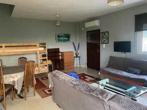 a living room with a couch and a bed at Patras Ressort in Patra