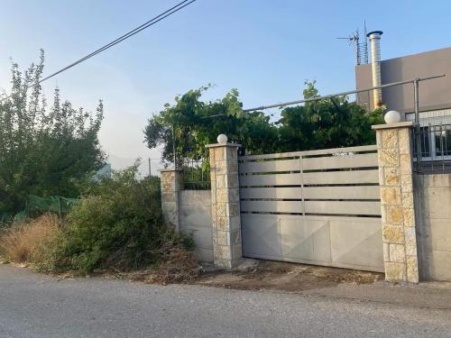 a fence with a gate on the side of a street at Patras Ressort in Patra