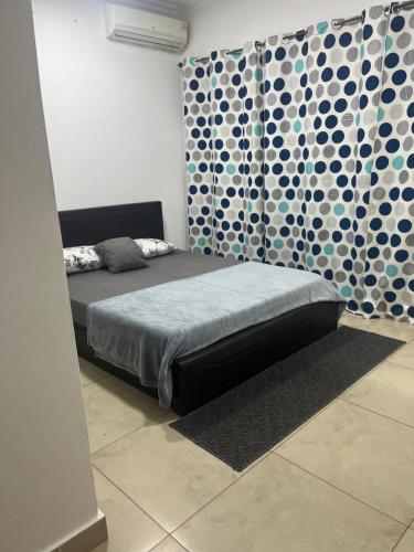 a bedroom with a bed and a patterned curtain at Avant Garde Luxury Apartment in Accra
