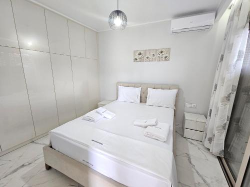 a white bedroom with a white bed in a room at GREY LUXURY HOUSE in Ýpsos