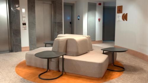a chair and two tables in a room at Kleopatra Dreams Beach Hotel in Alanya