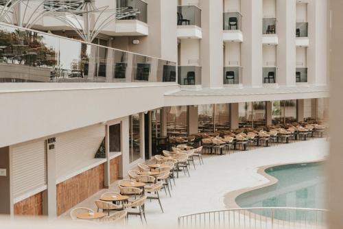 an internal view of a hotel with chairs and a swimming pool at Kleopatra Dreams Beach Hotel in Alanya