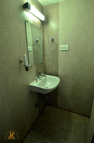 a bathroom with a sink and a mirror at Royal Serene Villas in Ooty