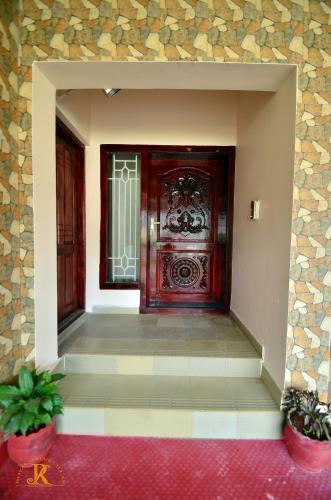 an entrance to a building with a large wooden door at Royal Serene Villas in Ooty