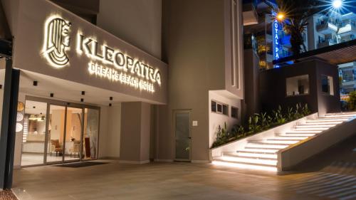 a store with a sign on the side of a building at Kleopatra Dreams Beach Hotel in Alanya