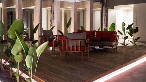 a living room with a couch and chairs and plants at Kleopatra Dreams Beach Hotel in Alanya