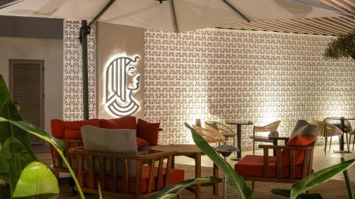 a room with chairs and a table with an umbrella at Kleopatra Dreams Beach Hotel in Alanya