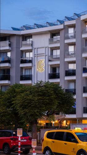 a yellow van parked in front of a building at Kleopatra Dreams Beach Hotel in Alanya