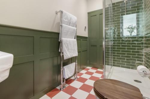 a bathroom with a toilet and a glass shower at The Old Kitchen Exford in Wheddon Cross