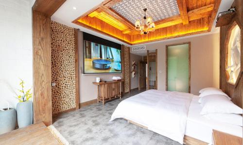 a bedroom with a large bed with a wooden ceiling at Pure House in Zhangjiajie