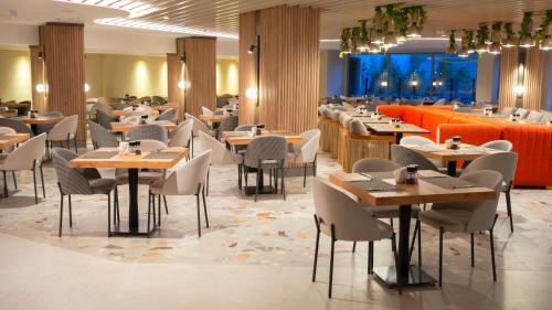 a restaurant with tables and chairs in a room at Kleopatra Dreams Beach Hotel in Alanya
