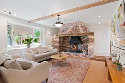a living room with a brick fire place at The Manor at Minstrel Court in Cambridge